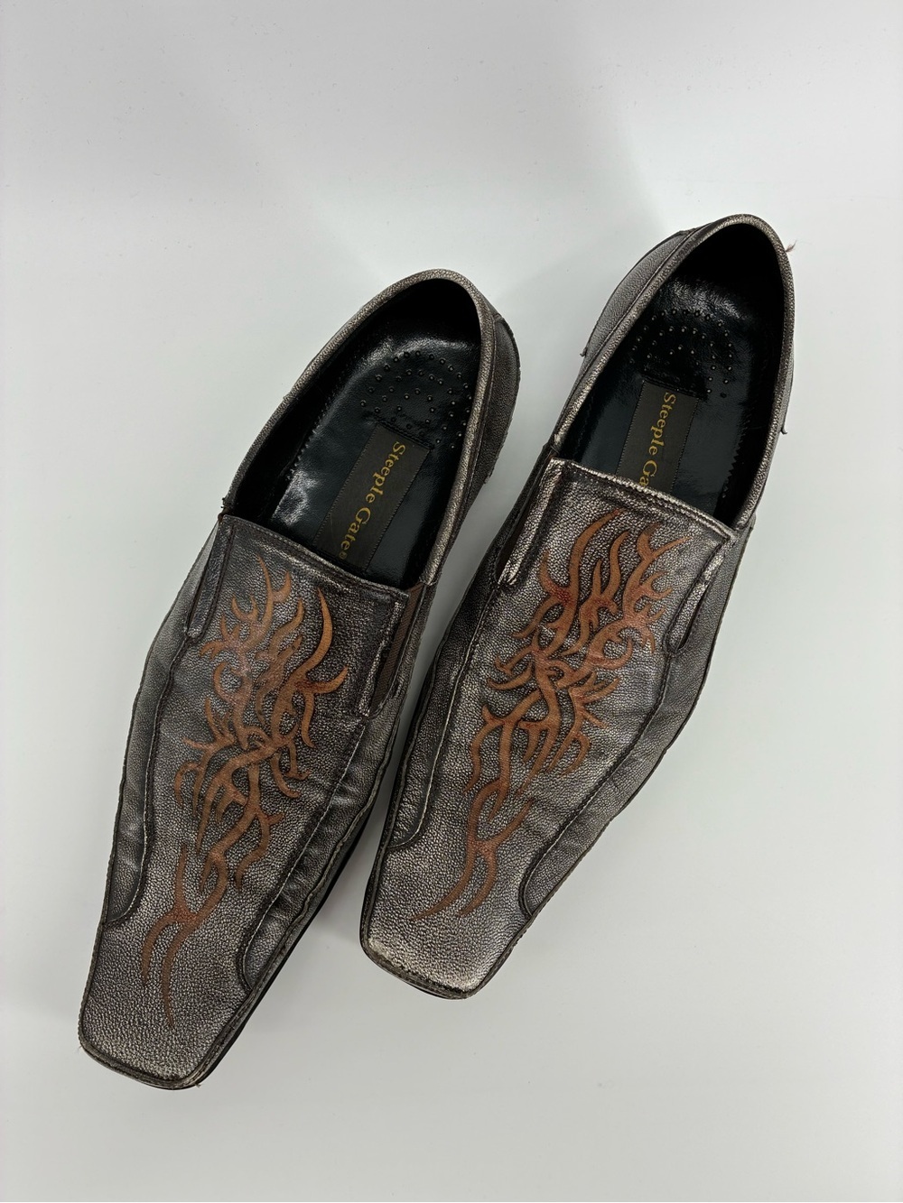 Steeple Gate Leather Men’s Metallic Gray Slip-On Loafers with Brown Flame Design